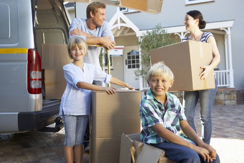 Packed boxes and furniture prepared for temporary storage near Highams Park